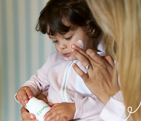 Girl with mother holding Epaderm cream