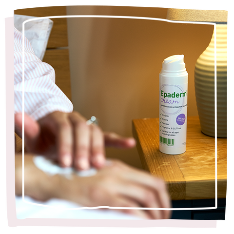 women applying epaderm cream on her hand with the Epaderm cream on the bedside table