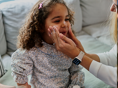 Girl having Epaderm cream applied to her face