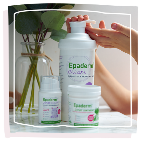 Epaderm cream and ointment on the side with a childs hand