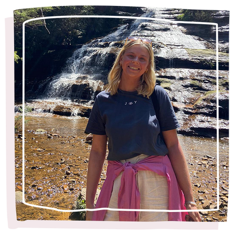 Women stood in front of a waterfall