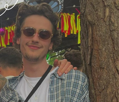 Man smiling at camera with sunglasses on