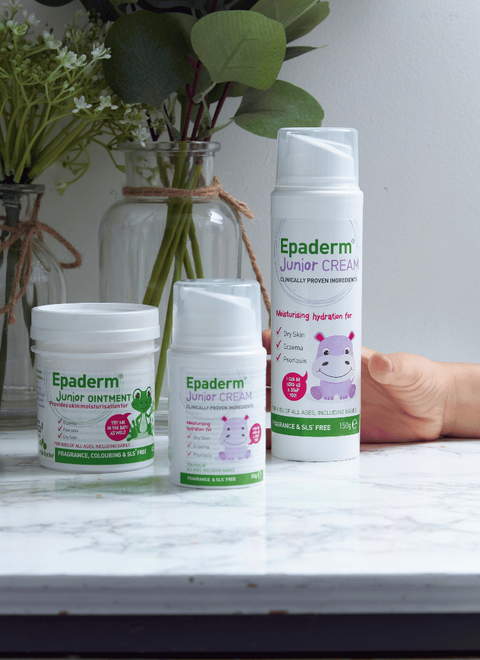 Epaderm Junior Cream and Ointment bottles on a marble surface with a blurred background